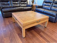 Overhead view of square Lane coffee table showing parquet top and surrounding furniture for scale