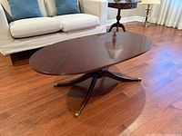 Top view of oval coffee table showing wood grain and pedestal legs