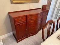 Front view of wooden sideboard showing drawers, cabinet, finish