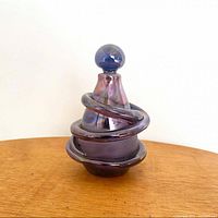 Perfume bottle with stopper in place showing overall design and iridescent finish