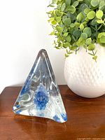Front view of clear glass pyramid with blue inclusions