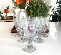 All six goblets front view showing daisy motif and stems