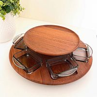 Top angled view of teak lazy susan with six smoked glass bowls