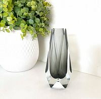 Front view of faceted smokey gray sommerso vase