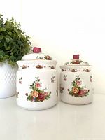 Front view of both Royal Albert Old Country Roses canisters with lids
