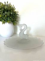 Platter front view showing koi fish handle and scalloped edge