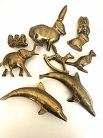 Group view of all eight brass animal figurines