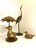 Group shot of all three brass bird sculptures