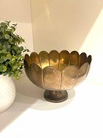 front view of scalloped brass pedestal bowl