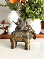 Right side view of brass elephant inkwell with bird finial