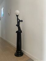 Full view of black ceramic dancer floor lamp turned off