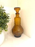 Full view of amber glass decanter with stopper