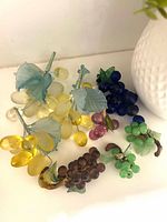 All seven glass grape clusters laid out showing colour variety