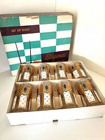 Open box showing eight decorated highball glasses with original inserts