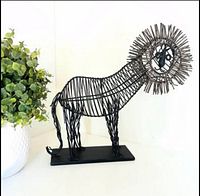 full view of wire lion sculpture on base