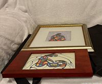 Both framed prints side by side, showing frame styles and artwork