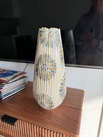 Full view of vase on table in front of TV