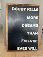 Front view showing full sign and quote text