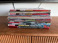 Stack of comics showing four Spider-Man Brand New Day trades, Batman Earth One, The Death of Jean DeWolff and numerous single issues