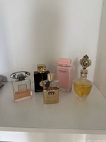 All five perfume bottles on shelf