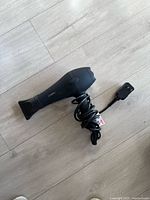 Side view of CONFU hair dryer, cord coiled