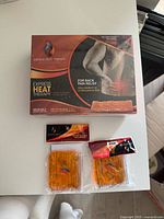 Front of boxed Express Heat Therapy pack with two smaller heat packs