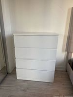 Front view of white 4-drawer dresser