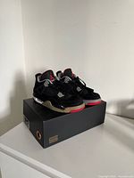 Pair of Air Jordan 4 sneakers on top of box
