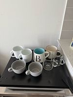 Group shot showing all eight mugs