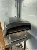 Front angled view of NutriChef propane pizza oven on stand