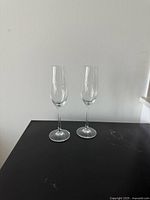 Front view of two Patron etched flutes