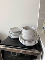 Stacked set of plates and bowls on countertop