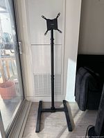 Full view of VIVO floor TV stand showing mount, pole, and base