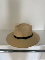 Full view of beige sun hat showing crown, brim, black band
