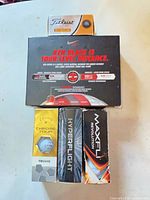 Stacked view of all boxed golf ball sleeves showing brands Nike RZN Black, Titleist, Callaway Chrome Tour Truvis, Hyperflight, Maxfli