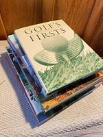 Stack of six golf coffee-table books with top title visible