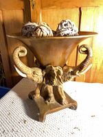 Full view of elephant pedestal bowl with rattan balls
