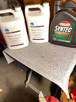 Overall view of two BioGuard anti-freeze jugs and one Castrol Syntec oil jug