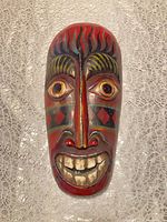Front view of painted wood tribal mask