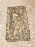 Front view of rectangular bas-relief plaque with Egyptian deity and hieroglyphics