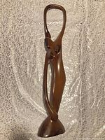 Front view of polished mahogany abstract human figure sculpture showing overall form and condition
