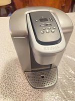 Front view of Keurig K-Elite K90 showing control panel, brew head and drip tray