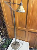 Full view of metal floor lamp with stained glass shade
