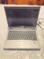 Laptop open showing screen, keyboard, touchpad