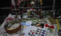 table overview with wire tree, ornaments, tin, cards, bulbs
