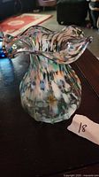 Front view of multicolour confetti art glass vase