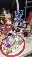 Overall view; jar of ornaments, sign, ceramic tray, shakers, tealights, dish visible