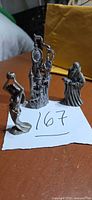 All three pewter fantasy figurines on paper marked 167