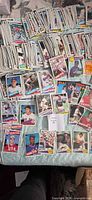 Wide view of large quantity of 1985 Topps baseball cards spread out and stacked