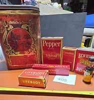 Group shot of all tins, boxes, bottle on table